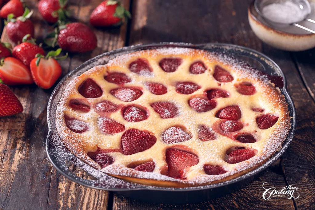 strawberry yogurt clafoutis dusted with powdered sugar