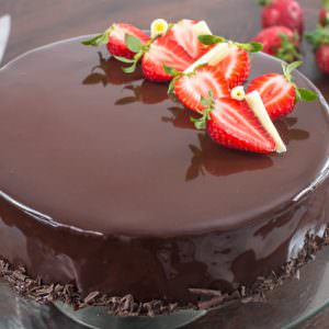 Strawberry Chocolate Mirror Cake topped with Strawberries