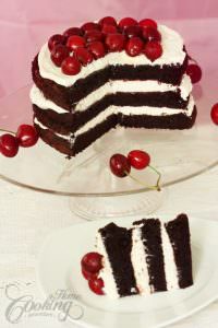 Cherry Chocolate Cake cut open with one serving in the front