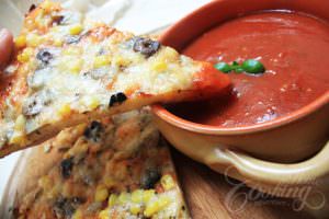 slice of pizza over tomato sauce 