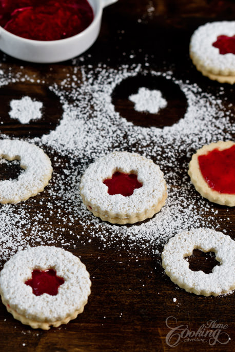 Strawberry Cardamom Linzer Cookies dusted with powdered sugar
