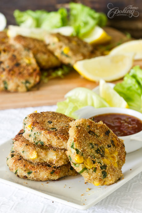 Potato Tuna Patties on a plate with lime and salad on the side