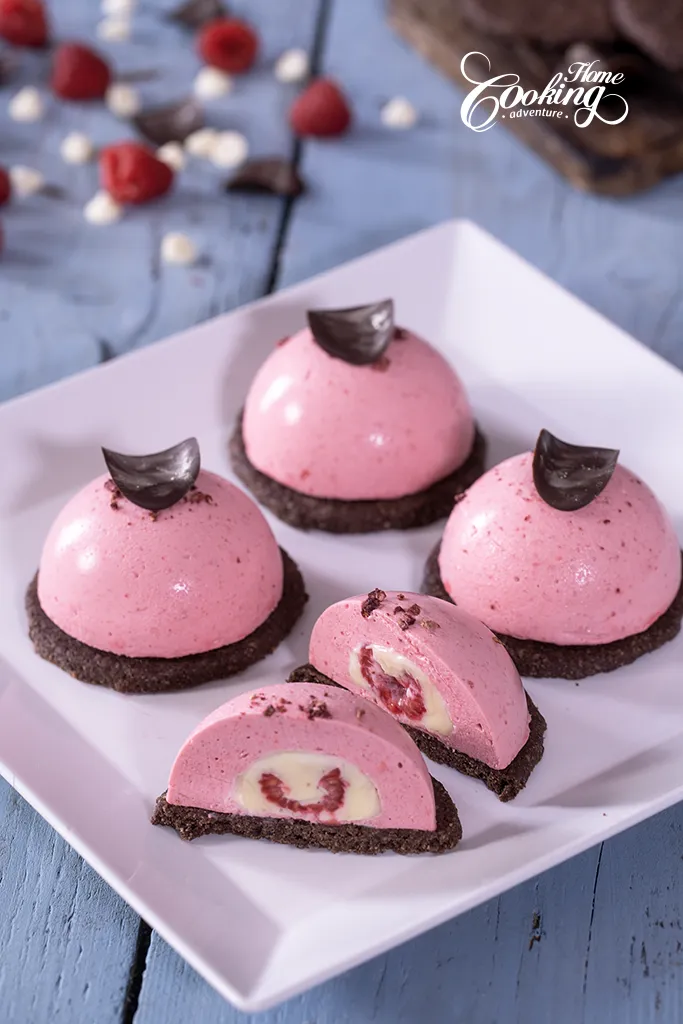 chocolate raspberry mousse domes with white chocolate and raspberry insert