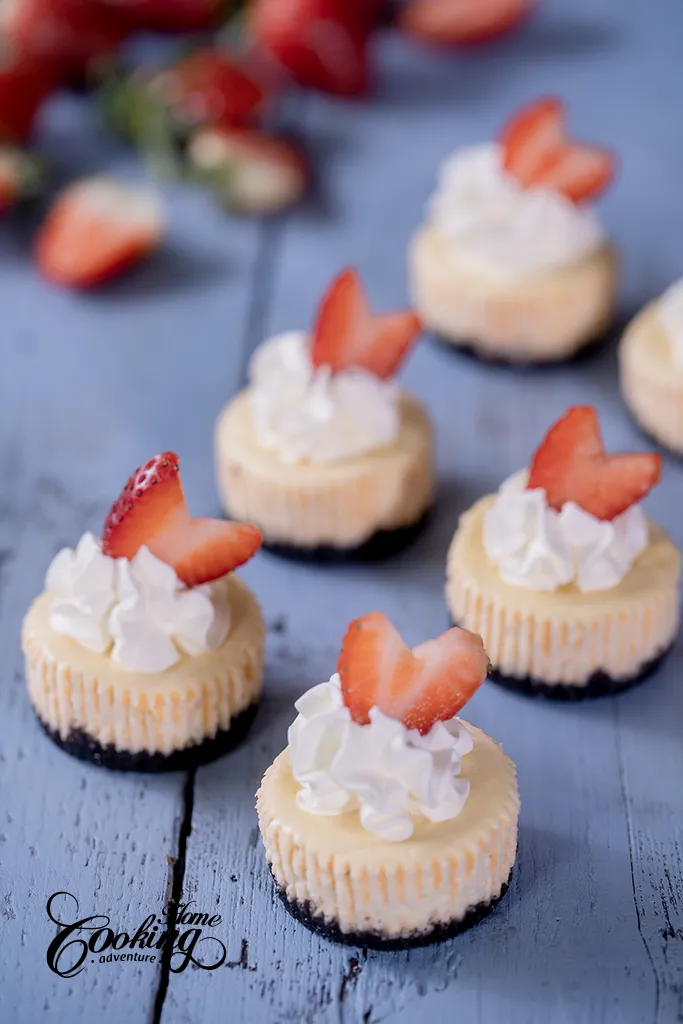 Mini cheesecakes with orea crust, whipped cream and fresh strawberries. 