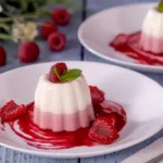 vanilla and raspberry panna cotta with raspberry sauce drizzle