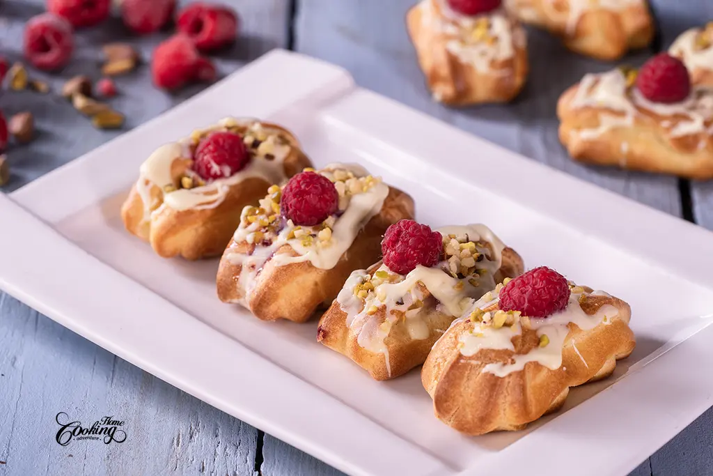 Mini eclairs filled with vanilla pastry cream and raspberries