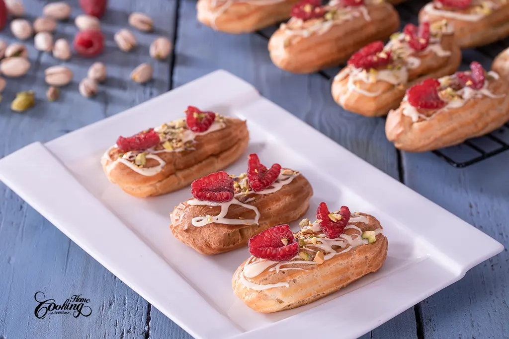 pistachio raspberry mini eclairs with chocolate drizzle 