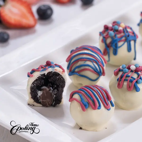 4th of July truffles - chocolate cake balls with white chocolate coating and red and white chocolate drizzle