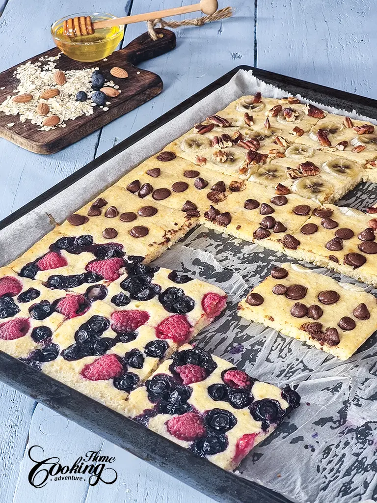 sheet pan pancakes - three different toppings - berries, chocolate and bananas with pecans