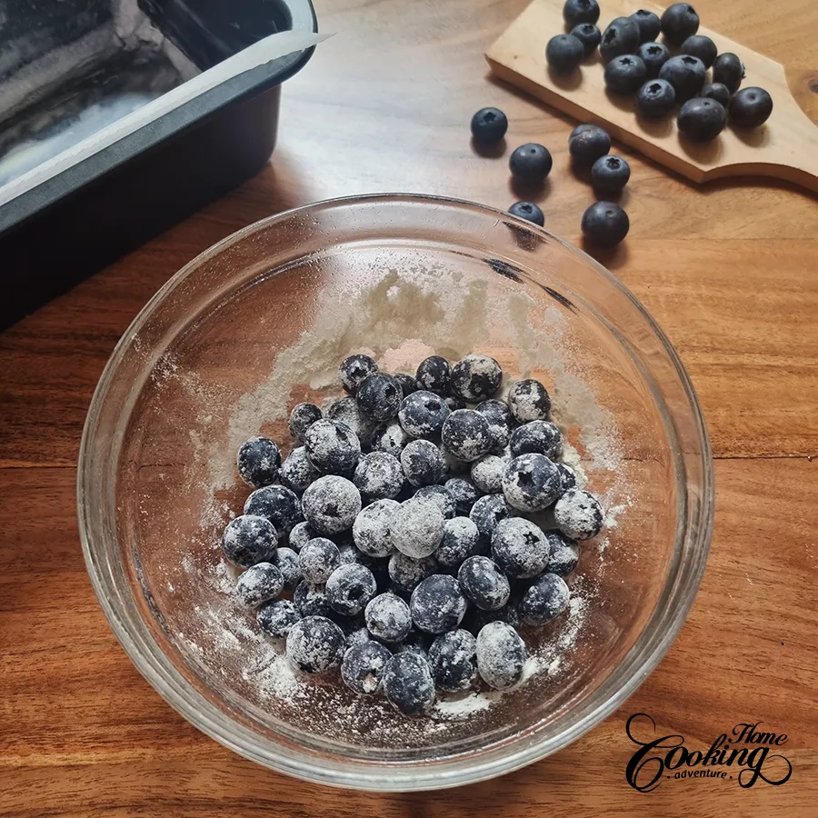 tossing blueberries with flour