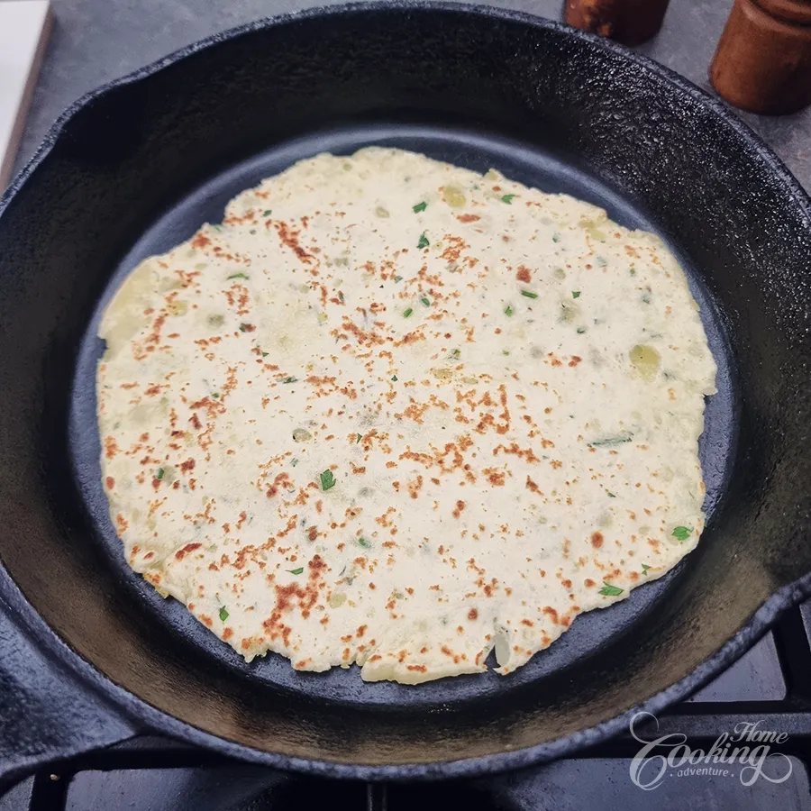 Heat a dry skillet over medium heat. Cook each tortilla for approximately 1–2 minutes per side, until golden spots appear and the dough is cooked through.